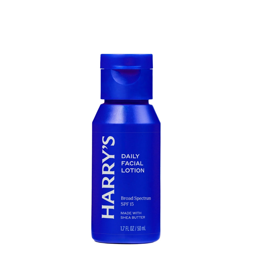 A blue bottle of Harry's Daily Facial Lotion SPF 15, featuring a matching blue flip-top cap, set against a plain white background.